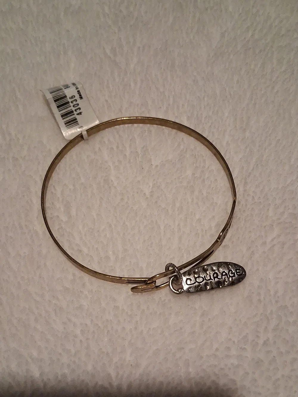 A.  Brighton Gold Tone Bangle with 'Courage' Charm